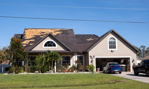 Damaged,House,Roof,With,Missing,Shingles,After,Hurricane,Ian,In